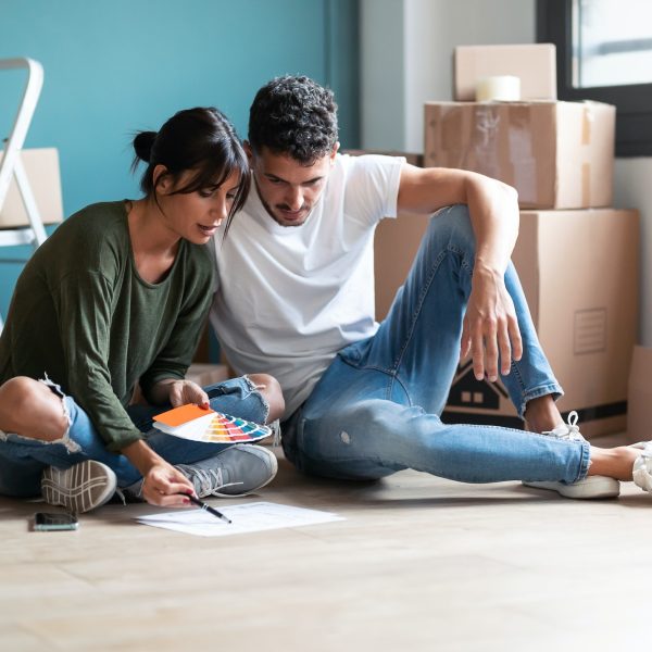 young-couple-choosing-colors-to-paint-the-walls-of-the-apartment-while-sitting-on-the-floor-.jpg